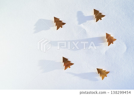 Minimalist Winter Scene With Gold Tree Cutouts Casting Shadows On White Background Minimalist Winter Scene With Gold Tree Cutouts Casting Shadows On White Background 138299454