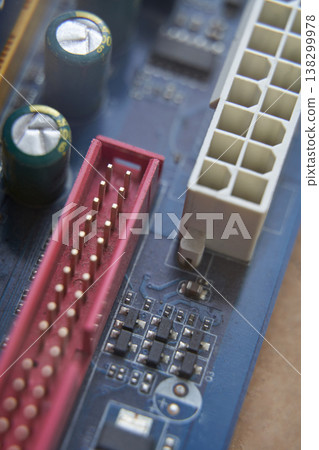 Close-up of computer motherboard with various connectors and electronic components 138299978