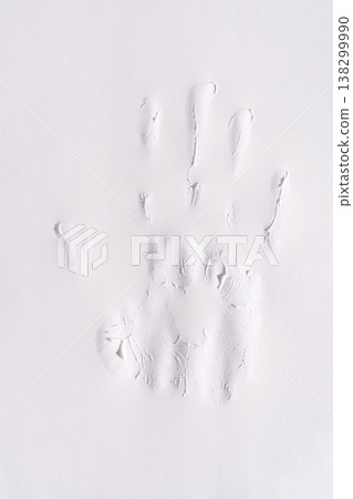 Embossed handprint impression on white paper symbolizing identity and creativity 138299990