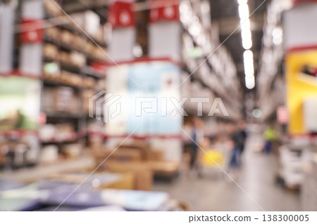 Blurry image of a busy warehouse interior with shelves and shopping carts Blurry image of a busy warehouse interior with shelves and shopping carts 138300005