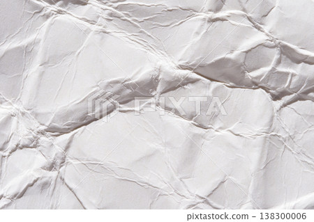Crumpled white paper texture with folded patterns and soft shadows for design backgrounds Crumpled white paper texture with folded patterns and soft shadows for design backgrounds 138300006