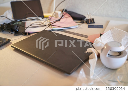 Cluttered Workspace With Laptop, Notebook, And Office Supplies On White Desk Cluttered Workspace With Laptop, Notebook, And Office Supplies On White Desk 138300034