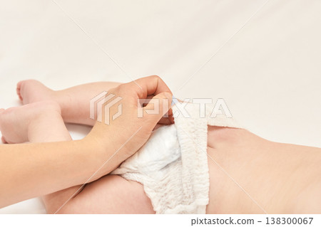 Caucasian Adult Changing Diaper Of Caucasian Baby On A Soft White Surface In A Gentle, Caring 138300067