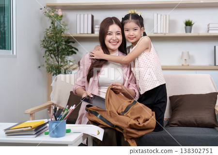 Mother and Daughter Sharing a Hug Before School Mother and Daughter Sharing a Hug Before School 138302751