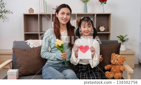 Mother's Day celebration with mother and daughter holding gifts 138302756