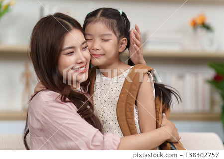 Mother hugging daughter before school Mother hugging daughter before school 138302757
