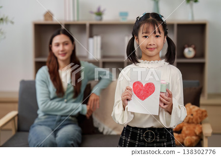 Mother's Day celebration with child gifting handmade card Mother's Day celebration with child gifting handmade card 138302776
