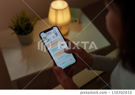 Smartphone controlling smart home lighting system Smartphone controlling smart home lighting system 138302818