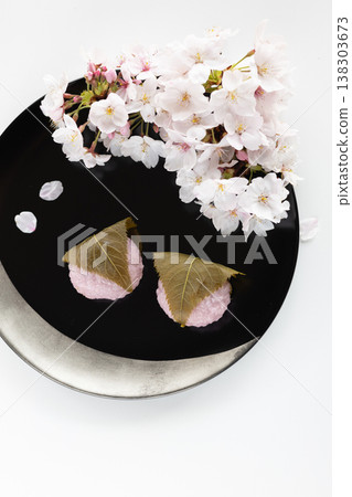 Sakura mochi and Somei Yoshino cherry blossoms served in a black lacquered bowl. Sakura mochi and Somei Yoshino cherry blossoms served in a black lacquered bowl. 138303673