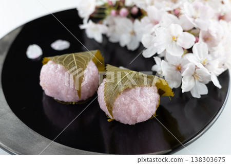 Sakura mochi and Somei Yoshino cherry blossoms served in a black lacquered bowl. Sakura mochi and Somei Yoshino cherry blossoms served in a black lacquered bowl. 138303675
