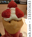 A crepe topped with lots of strawberries 138303683
