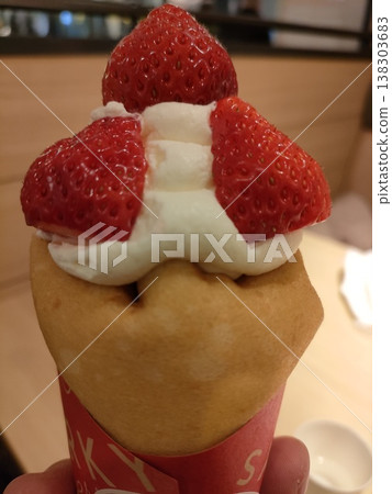 A crepe topped with lots of strawberries A crepe topped with lots of strawberries 138303683