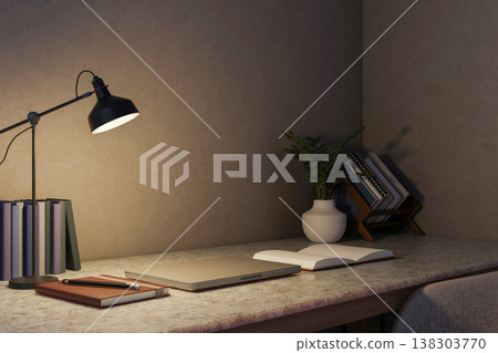 Closed laptop and open book and pencil under lamp light on marble counter table in dim room at night Closed laptop and open book and pencil under lamp light on marble counter table in dim room at night 138303770