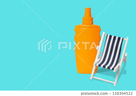 Sunscreen bottle and small beach chair ready for summer fun Sunscreen bottle and small beach chair ready for summer fun 138304522