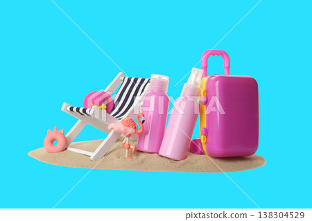 Bright beach items and a flamingo stand on sand ready for use 138304529