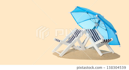 Beach chairs and umbrella set on sand at a summer beach Beach chairs and umbrella set on sand at a summer beach 138304539