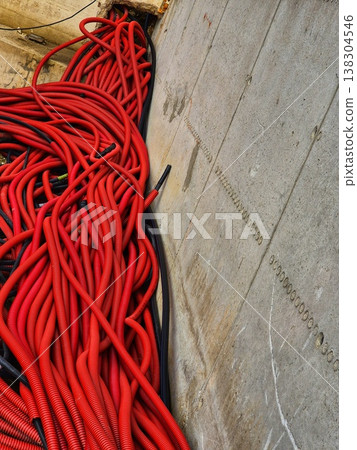 electrical cables in red protective corrugated tubes electrical cables in red protective corrugated tubes 138304546