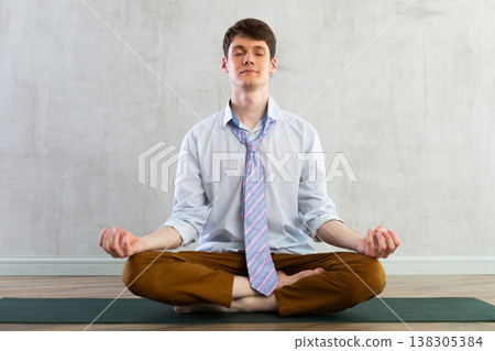 Young guy office worker doing yoga in studio Young guy office worker doing yoga in studio 138305384