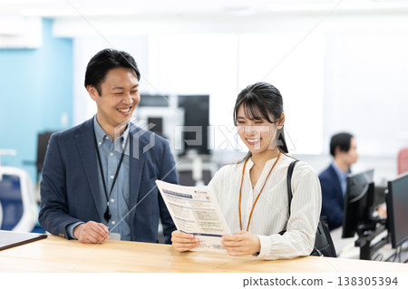 A manager and a sales employee having a conversation. A manager and a sales employee having a conversation. 138305394