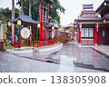 Traditional Chinese buildings and vermilion decorations reflected on the cobblestone streets after the rain. 138305908