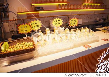 A street food counter lined with Chinese skewers, spicy snacks, and bamboo skewer dishes. 138306061