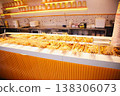 A street food counter lined with Chinese skewers, spicy snacks, and bamboo skewer dishes. 138306073