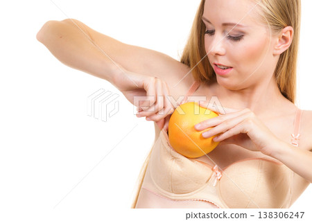 Woman small boobs puts big fruit in her bra 138306247