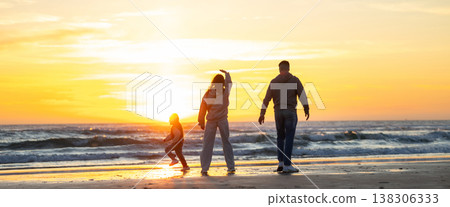 Family enjoying summer sunset walking on beach Family enjoying summer sunset walking on beach 138306333