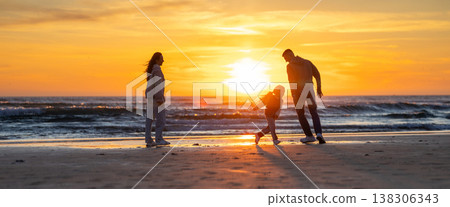 Family playing on beach enjoying beautiful sunset Family playing on beach enjoying beautiful sunset 138306343