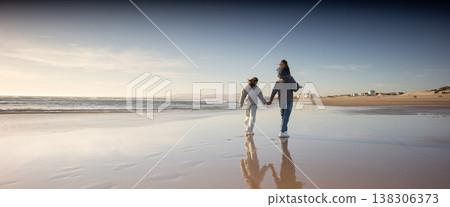 Family walking along beach enjoying togetherness and bonding Family walking along beach enjoying togetherness and bonding 138306373