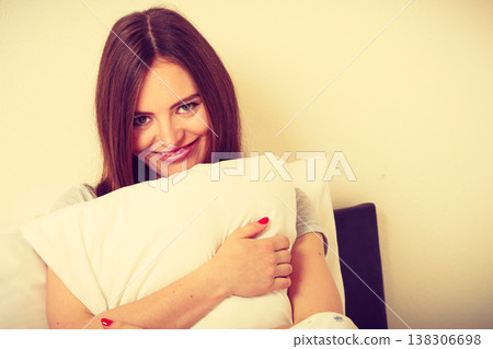 Tired girl hugging pillow. 138306698
