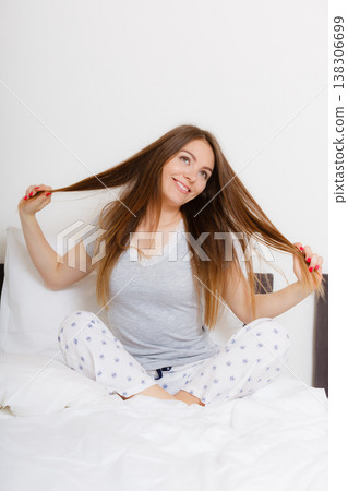 Girl pulling hair in bed. 138306699