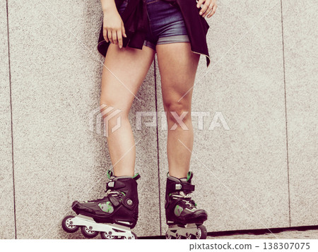 Woman riding roller skates Woman riding roller skates 138307075