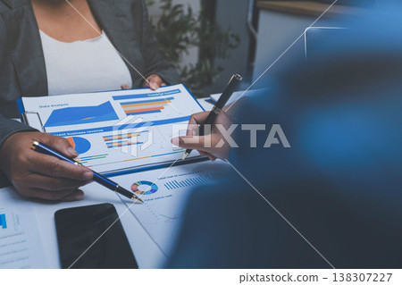 Auditor and accountant team working in office, analyze financial data and accounting record with calculator. Accounting company provide finance and taxation planning for profitable cash flow. 138307227