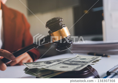 Judge gavel with Justice lawyers having team meeting at law firm in background. Notary with client in office 138307308