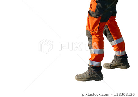 A builder's legs in protective workwear and boots A builder's legs in protective workwear and boots 138308126