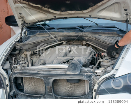 Mechanic inspecting car engine with open hood. Professional auto technician checking vehicle component under bonnet. Automotive maintenance service, repair work in garage, motor diagnostic. Mechanic inspecting car engine with open hood. Professional auto technician checking vehicle component under bonnet. Automotive maintenance service, repair work in garage, motor diagnostic. 138309094