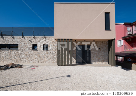Modular modern smart automated house with stone facade and unfinished work in progress exterior 138309629