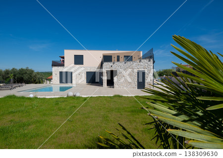 Modern modular smart automated house with stone facade, pool and landscaped lawn in contemporary exterior Modern modular smart automated house with stone facade, pool and landscaped lawn in contemporary exterior 138309630