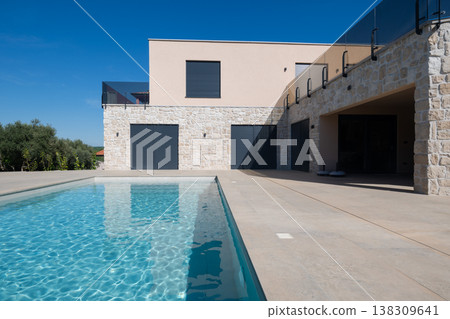 Modular modern smart automated house with stone exterior and swimming pool in minimalist contemporary design Modular modern smart automated house with stone exterior and swimming pool in minimalist contemporary design 138309641