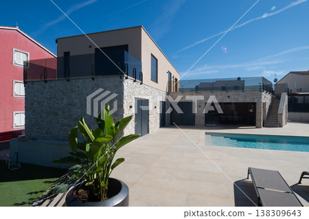 Modular modern smart automated house with pool and stone facade showing work in progress and aerial view 138309643