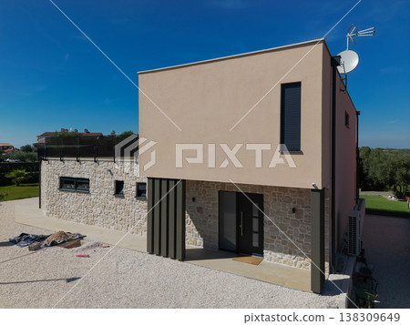 Modular modern smart automated house under construction with finished sections in aerial view Modular modern smart automated house under construction with finished sections in aerial view 138309649