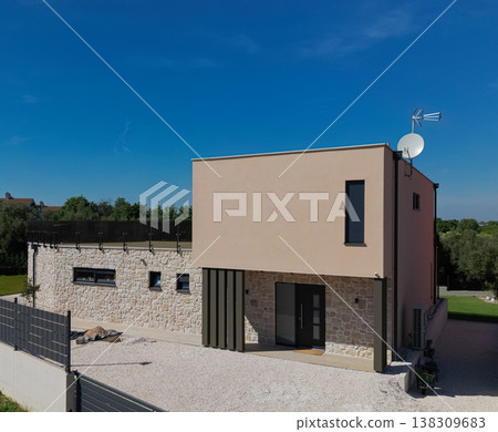 Modular modern smart automated house under construction with finished sections in aerial view 138309683