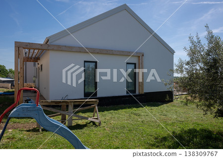 Modular modern minimalistic home under construction with energy-efficient design, pergola and solar-ready exterior Modular modern minimalistic home under construction with energy-efficient design, pergola and solar-ready exterior 138309767