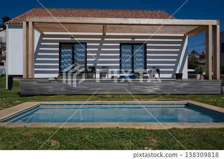 Modern minimalistic house with pergola, swimming pool and modular solar-ready high-efficiency heating and cooling Modern minimalistic house with pergola, swimming pool and modular solar-ready high-efficiency heating and cooling 138309818