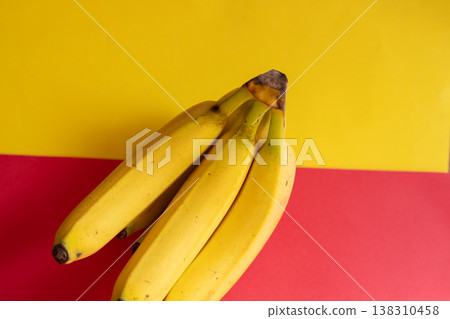 Bananas on a yellow and red background Bananas on a yellow and red background 138310458