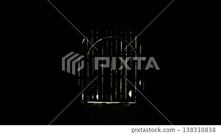 Entrance to a dark room with a wooden door and a window. 138310838
