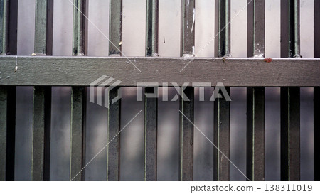 Detail of brown iron fence with natural light in the morning. Material texture fence. 138311019