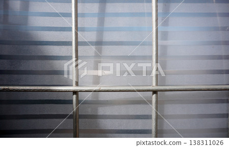 Detail of the iron fence of the house gate with plastic fiber. 138311026