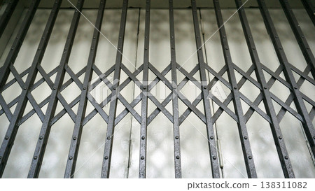 Metal grating on the wall of a building, stainless steel grating cover Close the gutter. 138311082